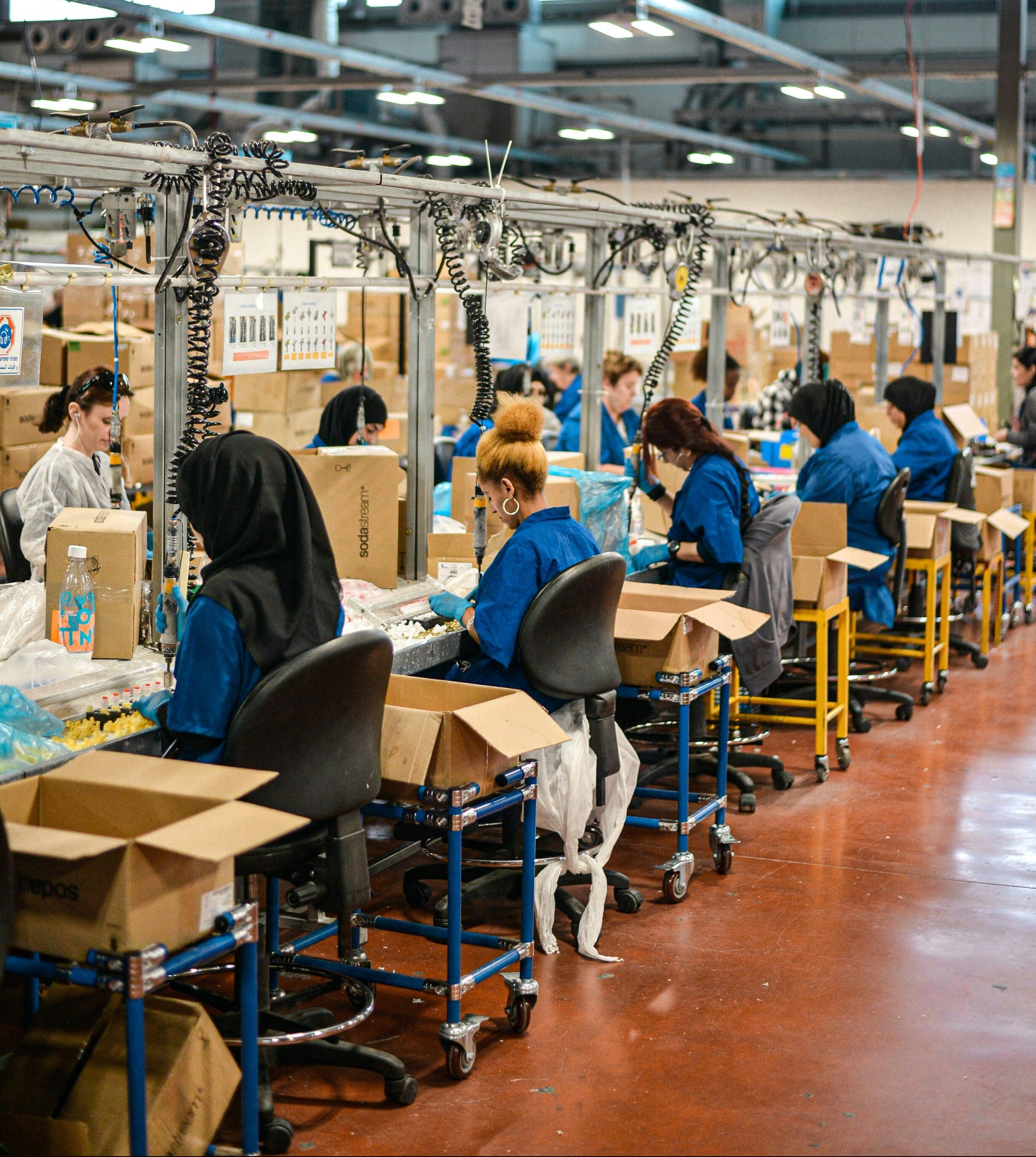 Factory workers packaging items in a warehouse setting