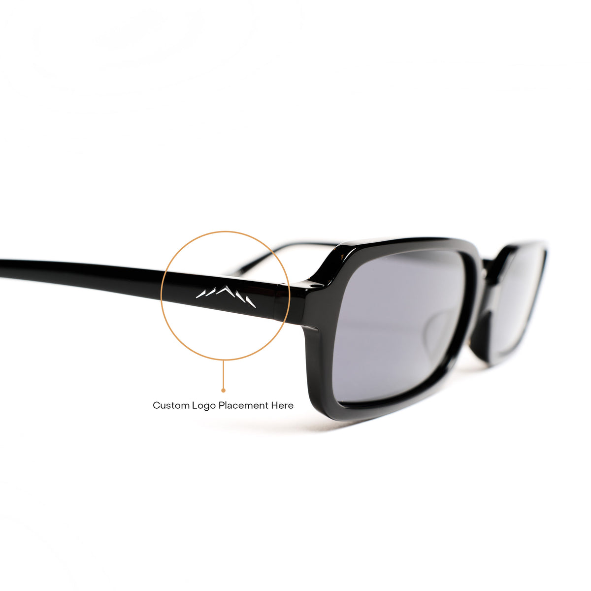 Black rectangular sunglasses with gray tinted lenses, shown on a white background with a circular callout highlighting the temple area and text reading 'Custom Logo Placement Here.'.