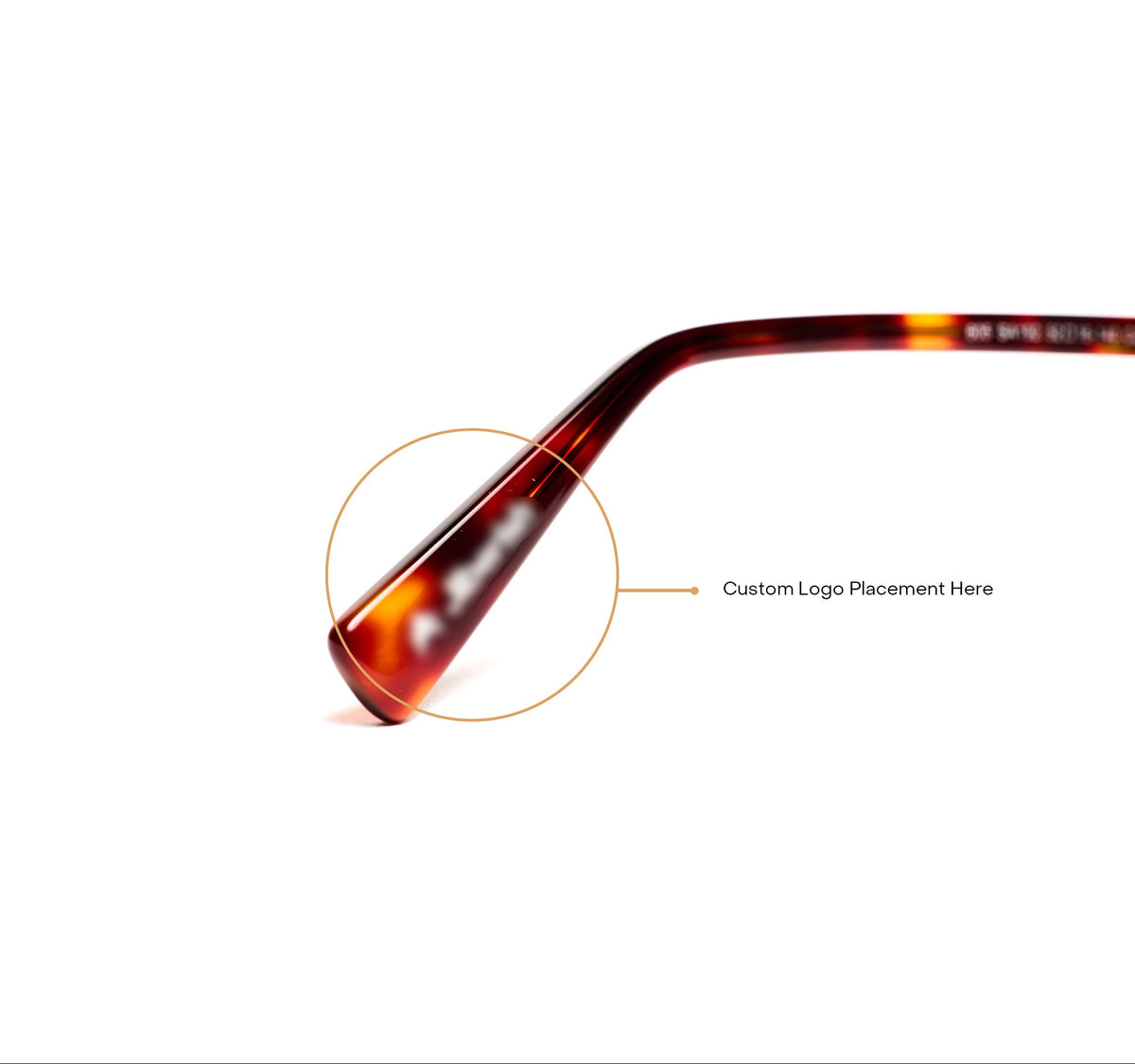 Close-up of a tortoiseshell acetate eyeglass temple tip with an orange circular highlight overlay and an arrow pointing to the text 'Custom Logo Placement Here' on a white background.
